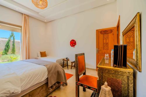 Una cama o camas en una habitación de Riad Tammam