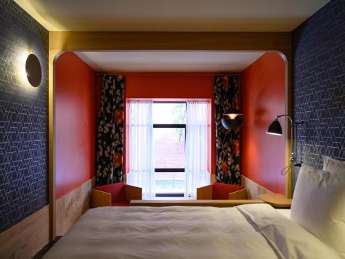 a bedroom with a large bed and a window at Hotel Frihavnen in Copenhagen