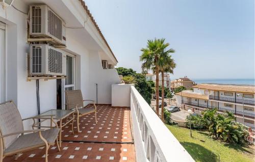 a balcony with a table and chairs and the ocean at 3 Bedroom Cozy Home In Fuengirola in Torremuelle