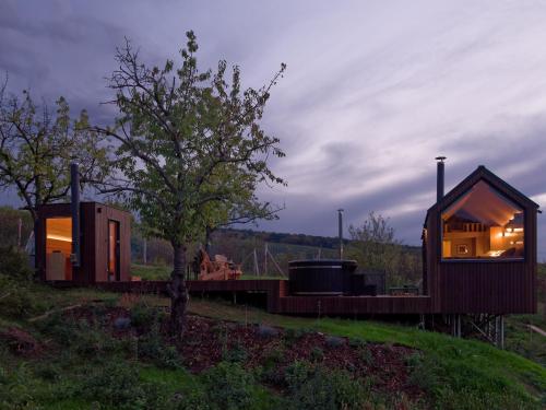 a couple of small houses in a field at NestOff in Romhány