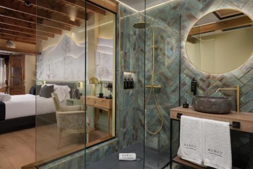 a bathroom with a shower and a sink and a bed at KARAT El Nogal Hotel Boutique & Spa in Escalona