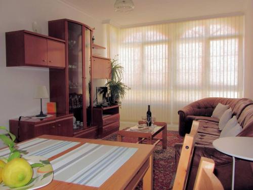 a living room with a couch and a table at Apartamentos Playa Monte Pindo - Morada Druida in O Pindo