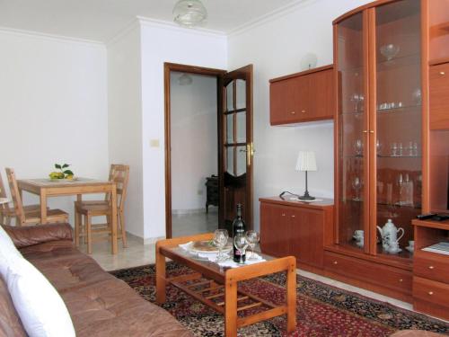 a living room with a couch and a table at Apartamentos Playa Monte Pindo - Morada Druida in O Pindo