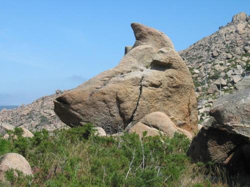 a large rock on the side of a mountain at Apartamentos Playa Monte Pindo - Morada Druida in O Pindo