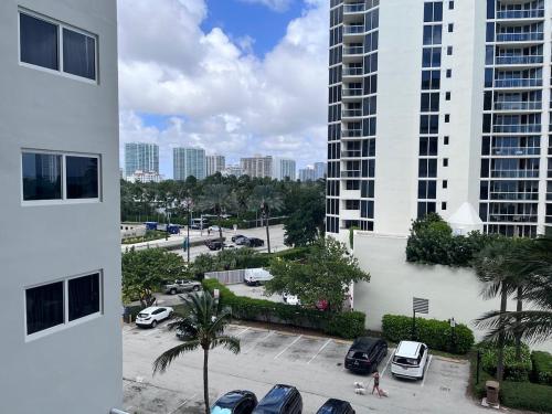 a view of a parking lot in front of a building at Sunny Isles Oceanfront Apartment for Two in Sunny Isles Beach