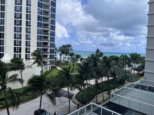 a view of the beach from the balcony of a resort at Sunny Isles Oceanfront Apartment for Two in Sunny Isles Beach