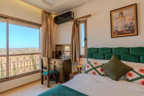 Una cama o camas en una habitación de Riad Tammam