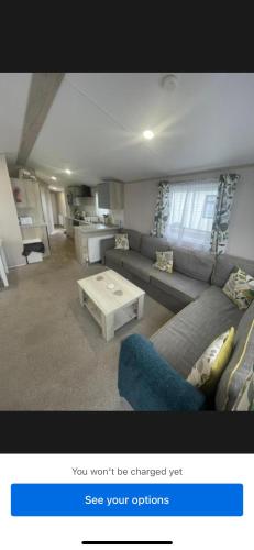 a living room with a couch and a coffee table at Loch View 30 in Stranraer