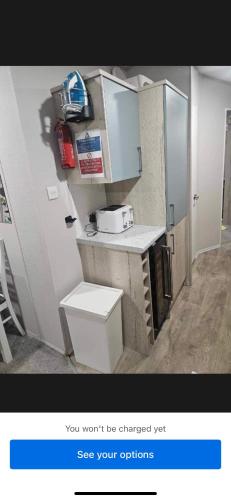 a small kitchen with a sink and a toilet at Loch View 30 in Stranraer