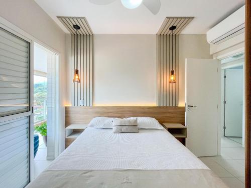 Postel nebo postele na pokoji v ubytování Bertioga | Pé na Areia Vista Mar Enxoval Completo