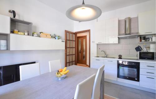 a kitchen with a table with a bowl of fruit on it at 2 Bedroom Awesome Apartment In Omegna in Omegna
