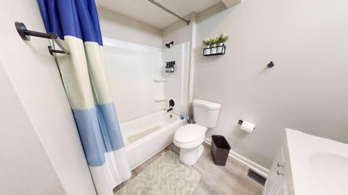 a bathroom with a toilet and a tub and a sink at 3 Bed 2 bath Pet Friendly in Historic Bates Hendricks in Indianapolis