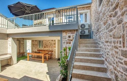 a staircase leading up to a house with a balcony at Nice Home In Murter With Private Swimming Pool, Can Be Inside Or Outside in Murter