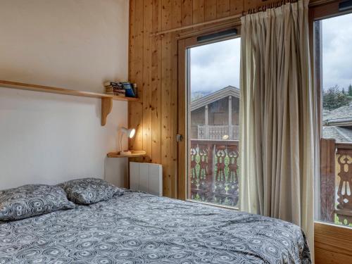 ムジェーヴにあるChalet à Megève, 4 chambres, proche centre, jardin, pour 10 pers. - Confort et services inclus - FR-1-453-1のベッドと大きな窓のある寝室