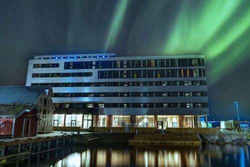 an office building with the northern lights above it at Scandic Sortland in Sortland