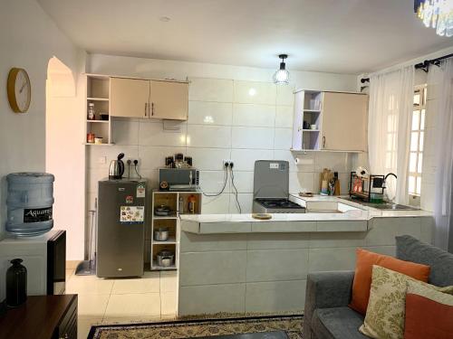 a kitchen with a refrigerator and a counter top at Valentine's Suite in Nairobi