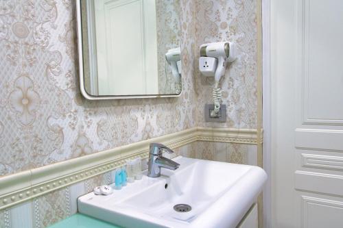 a bathroom with a sink and a mirror at Pilot By Haz Hotel in Baku