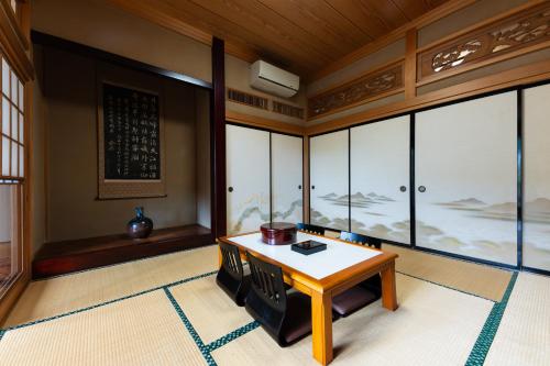 a room with a table and some windows at 春日光 HaruNikko in Nikko