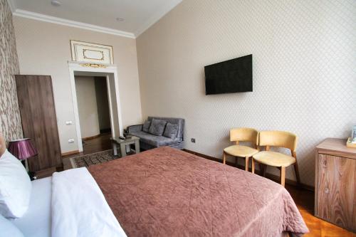 a hotel room with a bed and a chair at Pilot By Haz Hotel in Baku