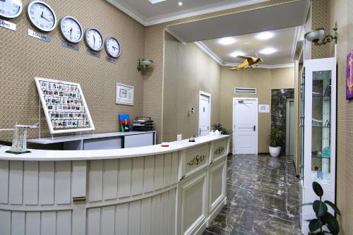 a large kitchen with clocks on the wall at Pilot By Haz Hotel in Baku