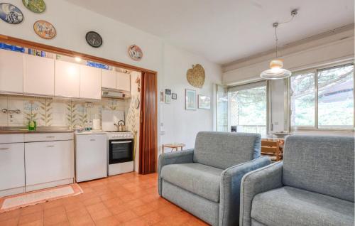 a kitchen with a couch and a chair in a room at 1 Bedroom Awesome Apartment In San Saturnino in Bracco