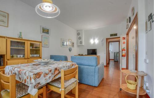 a dining room with a table and a blue chair at 1 Bedroom Awesome Apartment In San Saturnino in Bracco