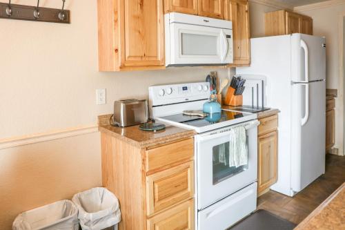 a kitchen with a white stove and a refrigerator at Yellowstone Gateway Inn in Gardiner