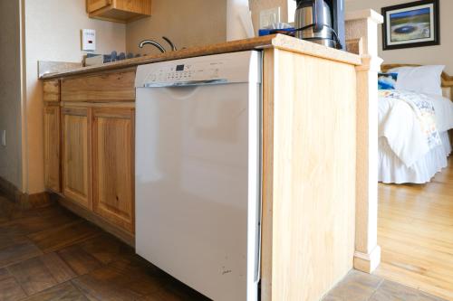a white dishwasher in a kitchen next to a counter at Yellowstone Gateway Inn in Gardiner