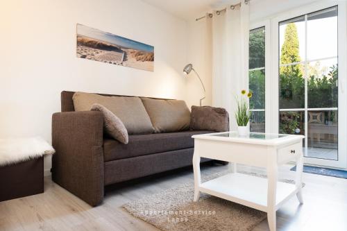 a living room with a couch and a table at Nautic W08 in Laboe