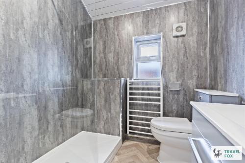 a bathroom with a shower toilet and a staircase at Bella's House 12mins bus to Motor Point Arena Free Street Parking in Nottingham