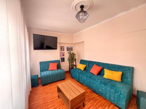 a living room with a blue couch and a table at Casa Grau in Sucre