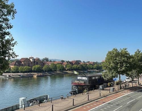 a boat is docked on a river with houses at Harbour House Bristol Entire townhouse with harbour views, sleeps up to 7 people in Bristol