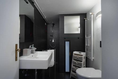 a bathroom with a white sink and a toilet at Villa Anna in Toscolano Maderno