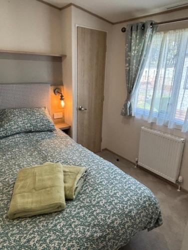 a bedroom with a bed with a pillow on it at Deblisa in Longtown