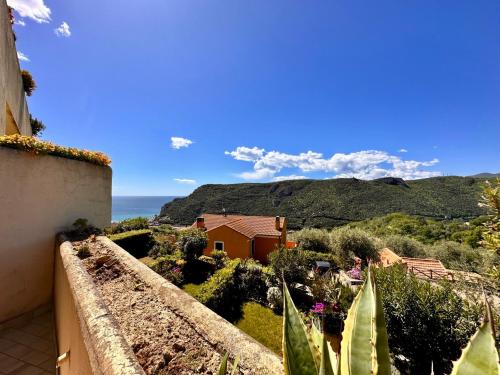 a view from the balcony of a house with mountains in the background at Hostdomus - Phil House in Finale Ligure