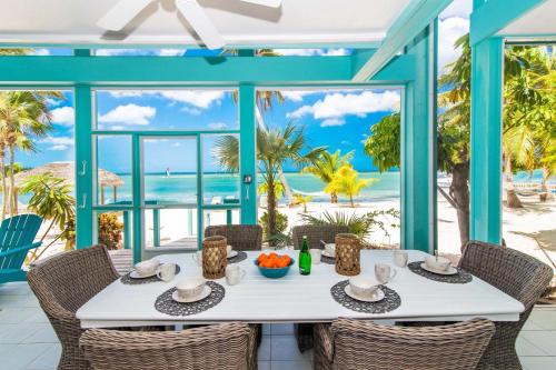 a dining table with a view of the beach at Bit of Heaven in Driftwood Village