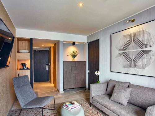 a living room with a couch and a table at Pullman Lima Miraflores in Lima