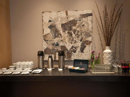a counter with cups and a laptop on a table at Pullman Lima Miraflores in Lima