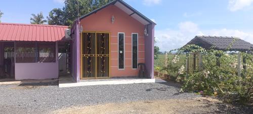 a smallshed with a gate and a fence at Homestay kak bee d' bendang in Jitra