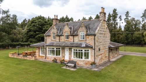 an aerial view of a house with a lawn at Balnagown Estates in Kildary