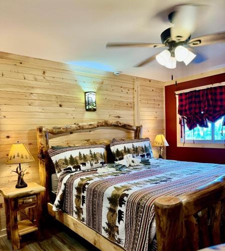 a bedroom with a bed and a ceiling fan at The Lake George Inn in Lake George