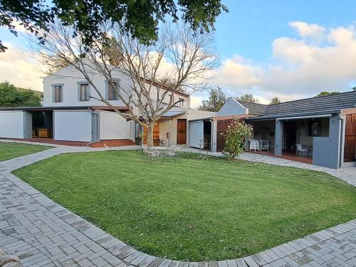 a house with a lawn in front of it at Grace Walk Guest House in Swellendam