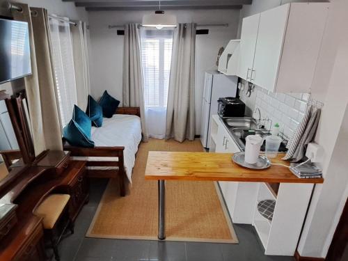 a small kitchen with a table in a small room at Grace Walk Guest House in Swellendam