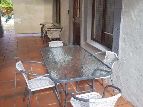a black table and chairs on a patio at Grace Walk Guest House in Swellendam