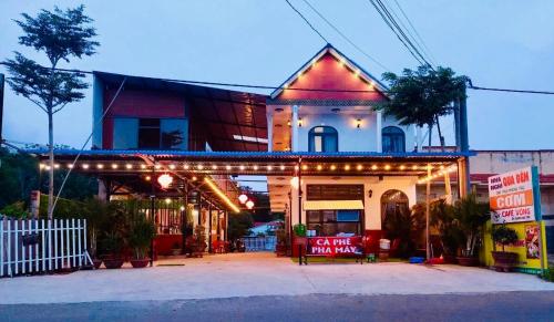 a building with lights on the front of it at Nhà Nghỉ Blue Sapphire Bình Châu Hotel in Xuyên Mộc