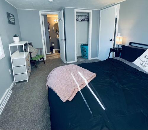 a bedroom with a bed with a pink blanket on it at 1 BR Cozy Apartment with Fire Pit Short walk to town in Nappanee