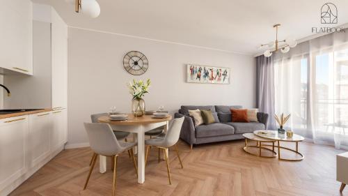 a living room with a table and a couch at City Center SPA Apartments Jaglana 6E,F in Gdańsk