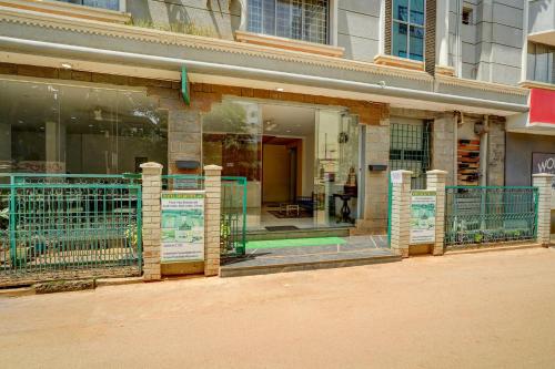 a store front with a gate in front of a building at Hotel O ALT pods in Bengaluru