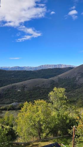 a view of a valley with trees and mountains at La Dote in Santo Stefano di Sessanio
