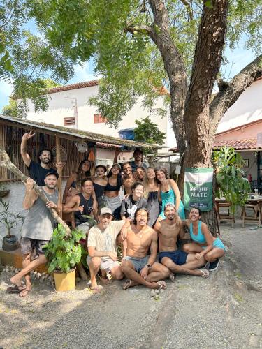 a group of people posing for a picture under a tree at Pipa Surf House in Pipa